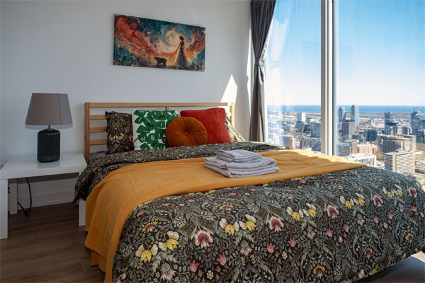 A couple enjoys a pedal boat ride in The picturesque backyard canal at CozyCotts Villa, alongside Lake Simcoe, Ontario, the closest lake to Toronto.